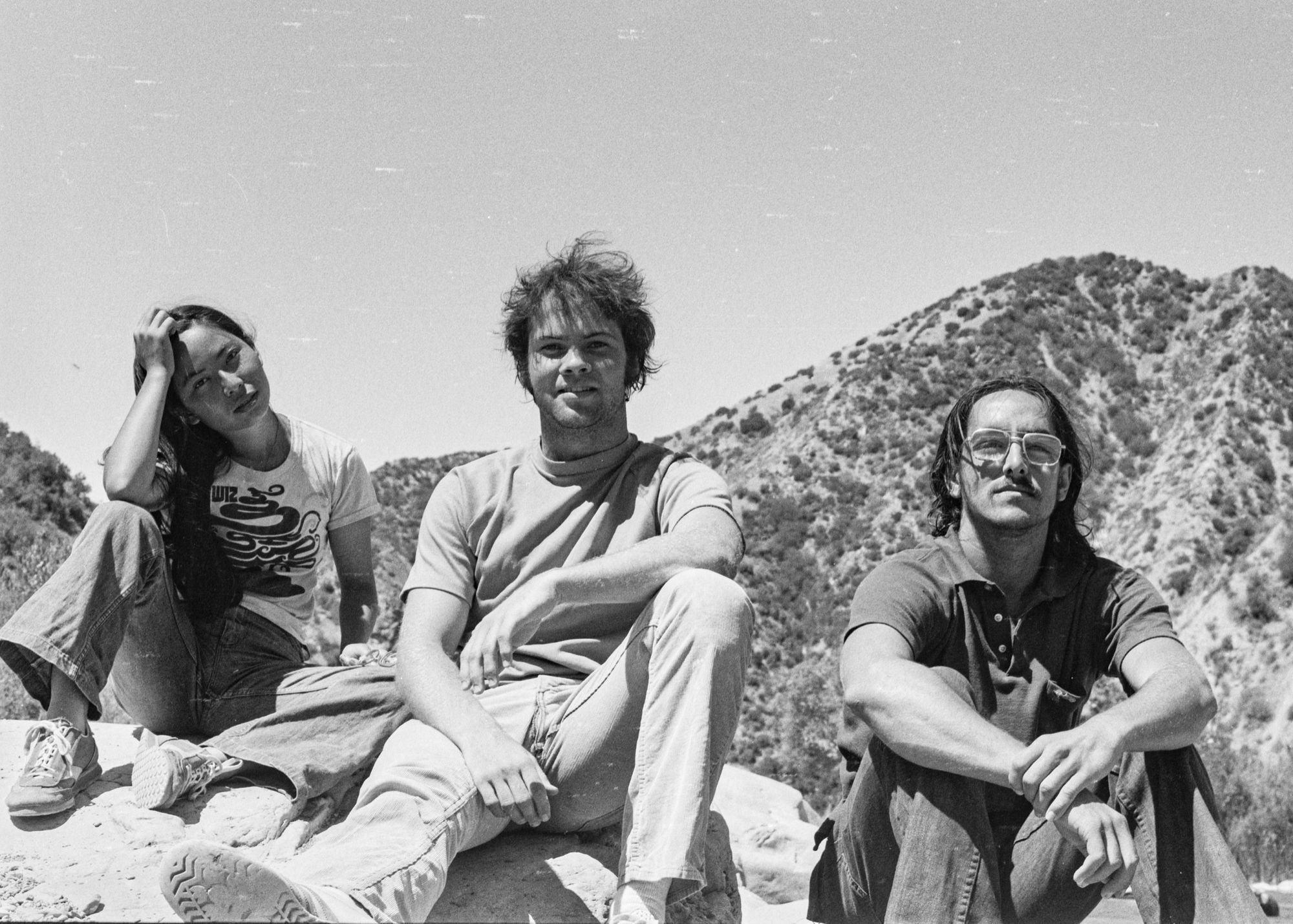 A group of people sitting on a rock

Description automatically generated with low confidence